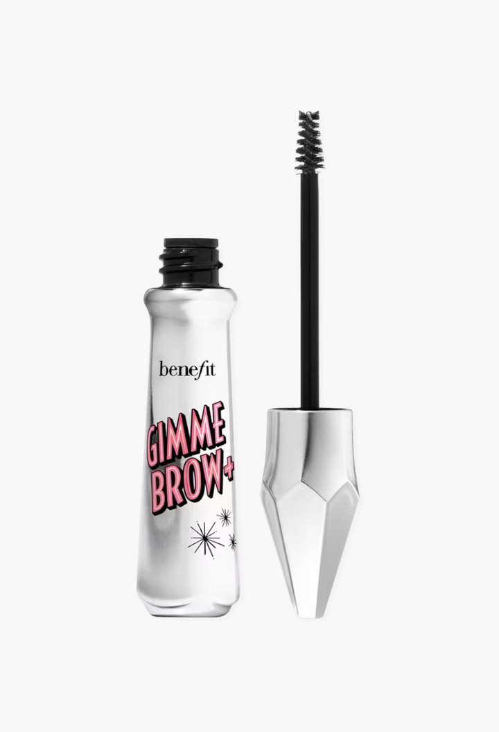 GLAM MODA Benefit Gimme Brow+ tinted volumizing eyebrow gel with a tapered applicator brush in a metallic silver tube.