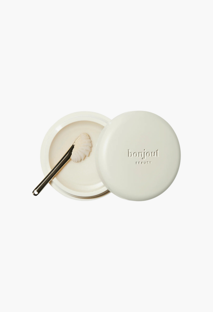 GLAM MODA Le Balm Duo unscented solid serum in a cream-colored jar with a small applicator spoon