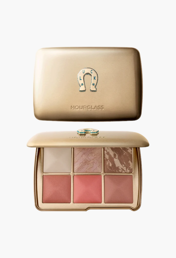 GLAM MODA Hourglass Ambient Lighting Edit Unlocked palette in gold tin with horseshoe charm and six powder shades.