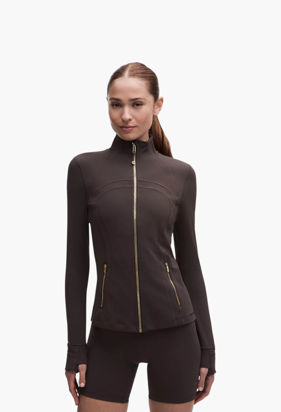 GLAM MODA Define Jacket Nulu in dark brown, featuring a slim fit, zippered pockets, and thumbholes on a model.