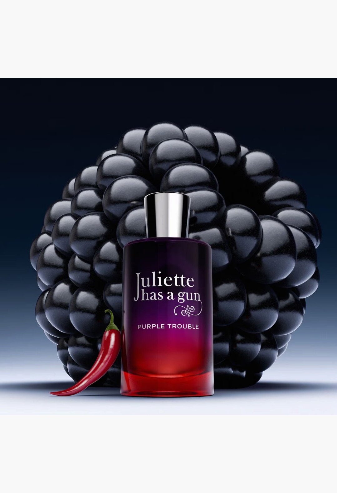 GLAM MODA Purple Trouble perfume bottle with blackberry and chili pepper accents on a dark background