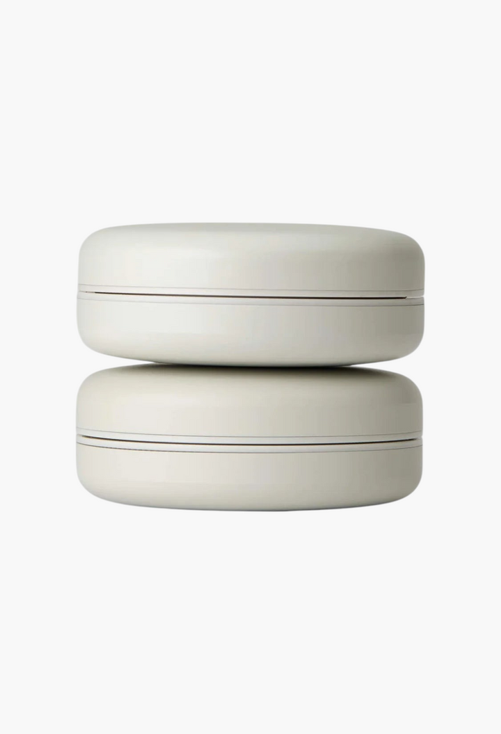 GLAM MODA Le Balm Duo unscented solid serum set in two stacked minimalist off-white round containers