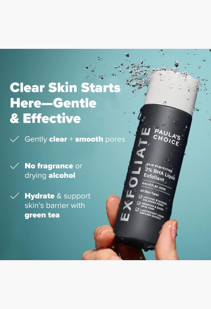 GLAM MODA Paula's Choice 2% BHA liquid exfoliating toner bottle held in hand with water splashes for clear skin
